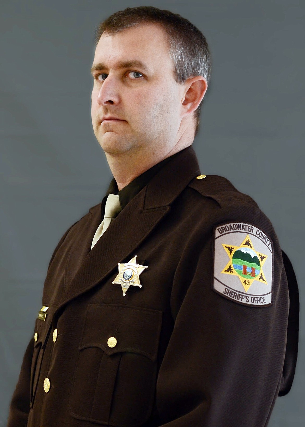 This undated photo provided by the Broadwater County Sheriff's Office shows Deputy Mason Moore, 38. Moore was killed early Tuesday, May 16, 2017, in a shootout that prompted a middle-of-the-night pursuit that spanned more than 100 miles (161 kilometers) across southwestern Montana, involving several law enforcement agencies. Before sunrise, the chase had ended with the vehicle driving on its rims, a suspect shot and hospitalized and his father under arrest, officials said. (Broadwater County Sheriff's Office via AP)