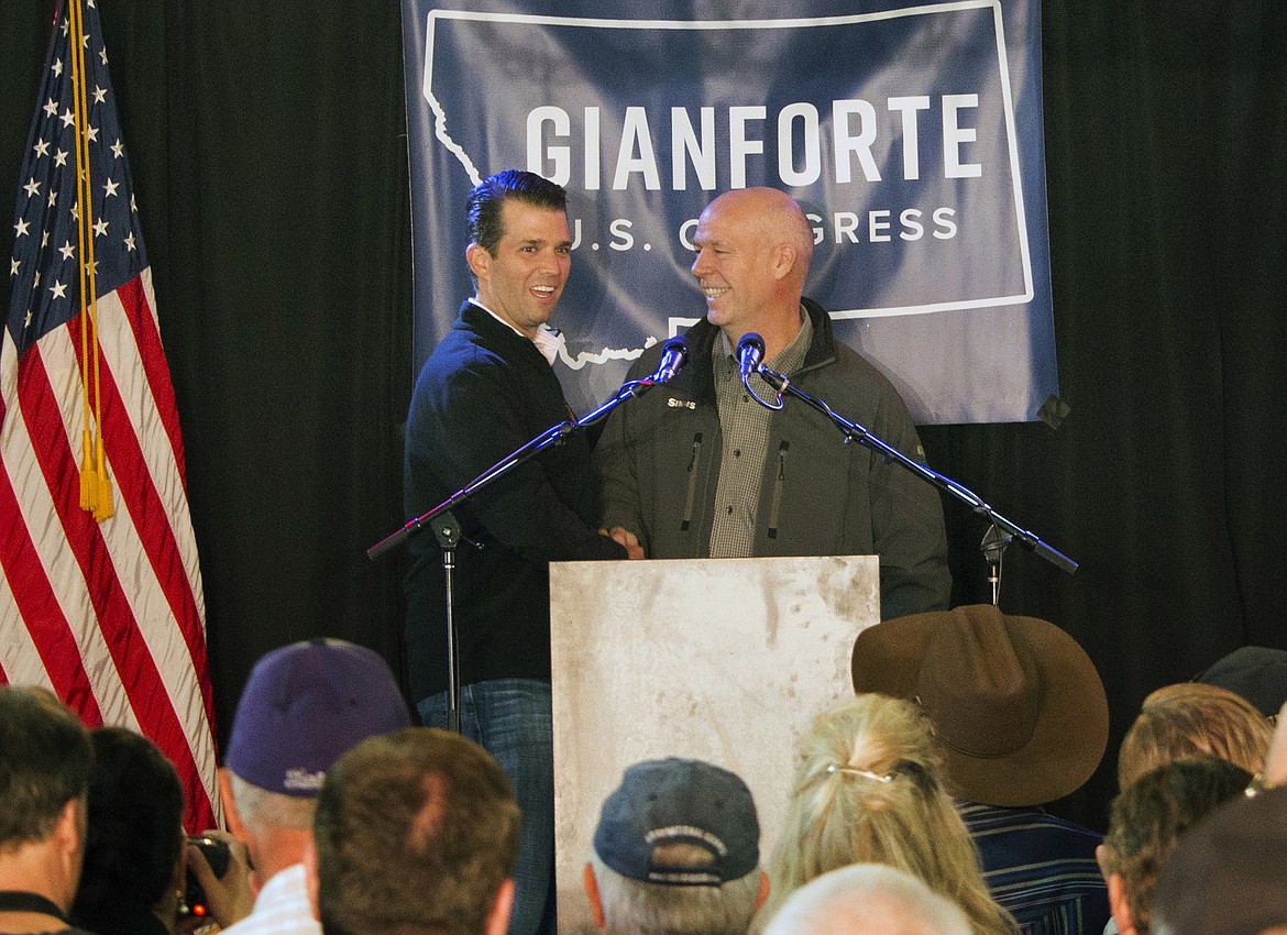 FILE - In this May 11, 2017, file photo Republican Greg Gianforte, right, welcomes Donald Trump Jr., the U.S. president&#146;s son, onto the stage at a rally in East Helena, Mont. Gianforte won Montana&#146;s only U.S. House seat on Thursday, May 25, despite being charged a day earlier with assault after witnesses said he grabbed a reporter by the neck and threw him to the ground. (AP Photo/Bobby Caina Calvan, File)
