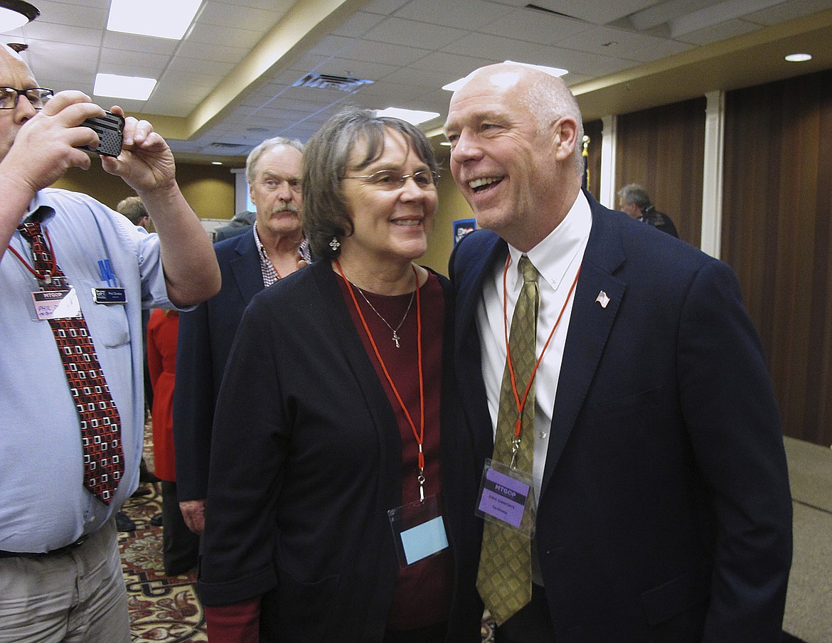 FILE - In this March 6, 2017, file photo, Greg Gianforte, right, receives congratulations from a supporter in Helena, Mont. Montana voters are heading to the polls Thursday, May 25, 2017, to decide a nationally watched congressional election amid uncertainty in Washington over President Donald Trump&#146;s agenda and his handling of the country&#146;s affairs. (AP Photo/Matt Volz, File)