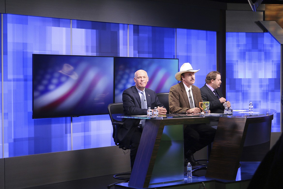 FILE - In this April 29, 2017, file photo, three candidates, from left, Republican Greg Gianforte, Democrat Rob Quist and Libertarian Mark Wicks vying to fill Montana&#146;s only congressional seat await the start of their only televised debate in Great Falls, Mont. Montana voters are heading to the polls Thursday, May 25, 2017, to decide a nationally watched congressional election amid uncertainty in Washington over President Donald Trump&#146;s agenda and his handling of the country&#146;s affairs. (AP Photo/Bobby Caina Calvan, file)