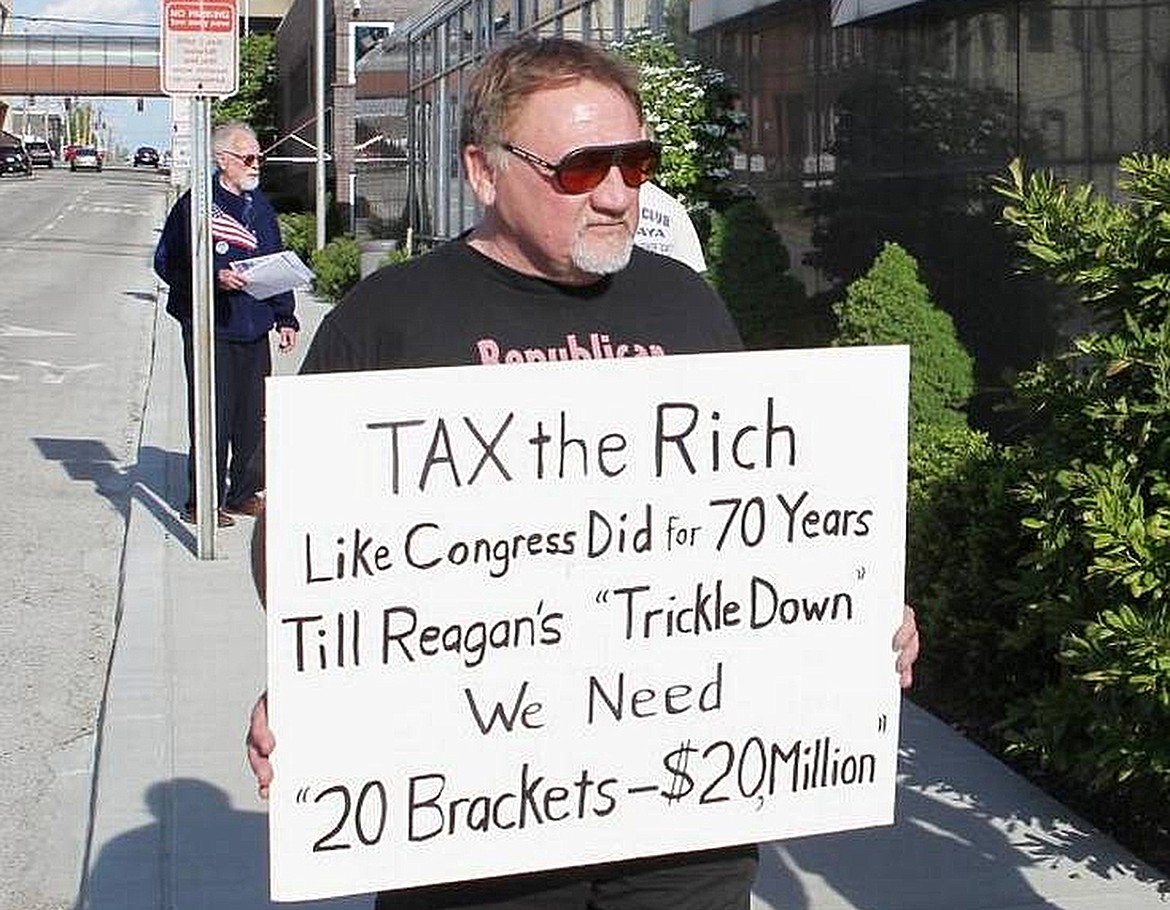 In this undated file photo, James Hodgkinson holds a sign during a protest outside of a United States Post Office in Belleville, Ill. Hodgkinson has been identified as the suspect in the Wednesday, June 14, 2017, Washington D.C. shooting. (Derik Holtmann/Belleville News-Democrat via AP)