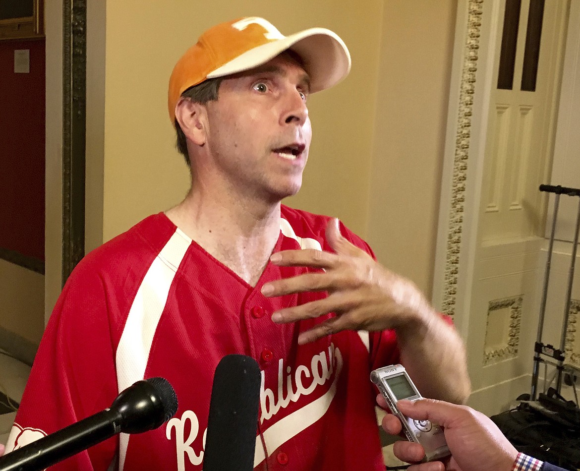 Rep. Chuck Fleischmann, R-Tenn., still wearing his baseball shirt, describes for reporters on Capitol Hill in Washington, Wednesday, June 14, 2017, the scene at a congressional baseball practice in Alexandria, Va., earlier where a gunman opened fire wounding House Majority Whip Steve Scalise, R-La. during a Congressional baseball practice. (AP Photo/Matthew Daly)