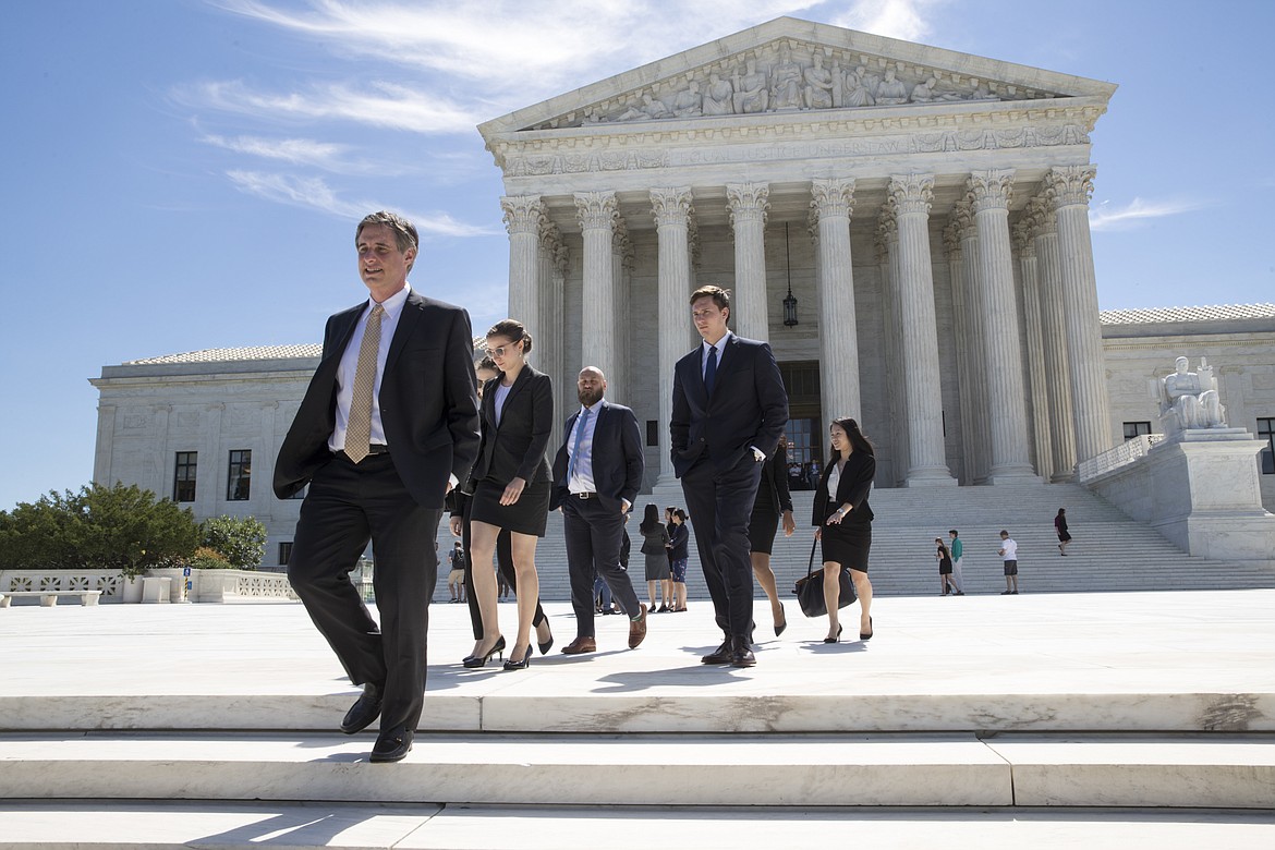 People leave the Supreme Court in Washington, Monday, June 26, 2017, as justices issued their final rulings for the term. The high court is letting a limited version of the Trump administration ban on travel from six mostly Muslim countries to take effect, a victory for President Donald Trump in the biggest legal controversy of his young presidency. (AP Photo/J. Scott Applewhite)