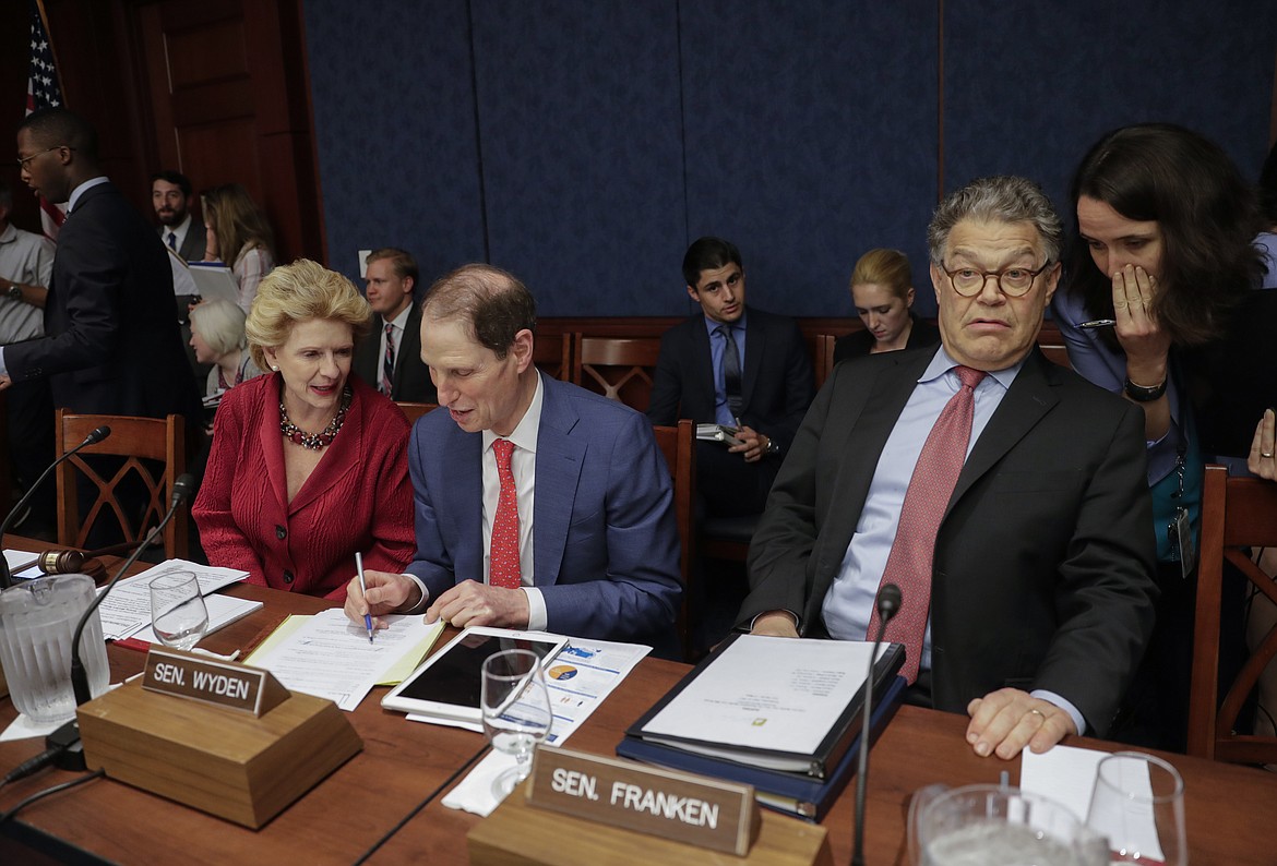 Democratic senators hold a hearing hosted by Democratic Policy and Communications Committee Chair Debbie Stabenow, D-Mich., left, with Sen. Ron Wyden, D-Ore., center, and Sen. Al Franken, D-Minn., about how they say the GOP health care bill could hurt rural Americans, at the Capitol in Washington, Wednesday, June 21, 2017. Senate Majority Leader Mitch McConnell was expected to push for a vote next week on the legislation, which would eliminate much of Obama's 2010 overhaul and leave government with a diminished role in providing coverage and helping people afford it. (AP Photo/J. Scott Applewhite)