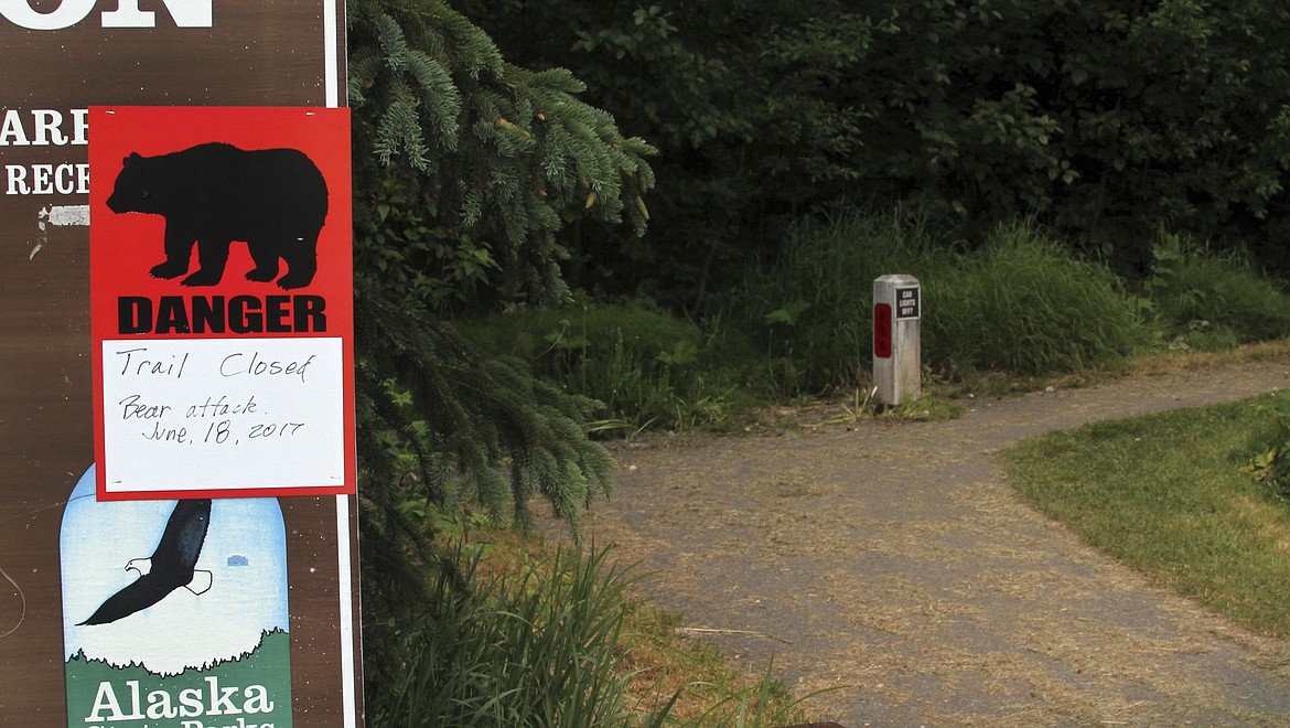 A sign warns people that the trail head is closed on Monday, June 19, 2017, after a fatal bear mauling at Bird Ridge Trail in Anchorage, Alaska. Authorities say a black bear killed a 16-year-old runner while he was competing in an Alaska race on Sunday. (AP Photo/Mark Thiessen)