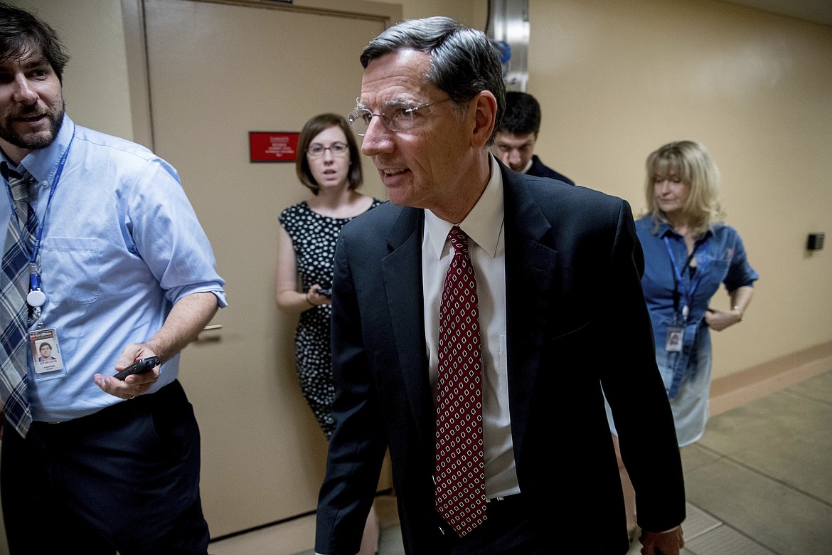 Sen. John Barrasso, R-Wyo. walks into the Capitol Building on Capitol Hill in Washington, Monday, July 17, 2017. The Senate has been forced to put the republican's health care bill on hold for as much as two weeks until Sen. John McCain, R-Ariz., can return from surgery. (AP Photo/Andrew Harnik)
