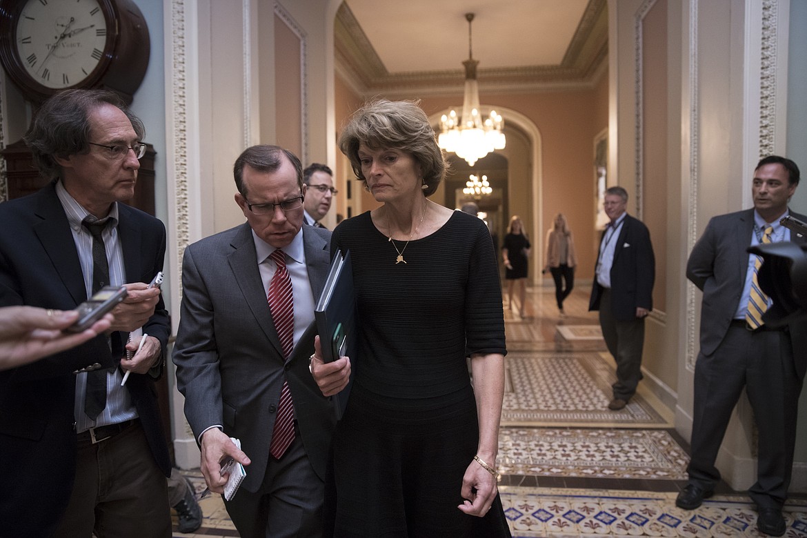 Sen. Lisa Murkowski, R-Alaska is approached by reporters as she enters the Senate chamber on Capitol Hill in Washington, Thursday, July 27, 2017, as the Republican majority in Congress remains stymied by their inability to fulfill their political promise to repeal and replace &#147;Obamacare&#148; because of opposition and wavering within the GOP ranks. (AP Photo/J. Scott Applewhite)