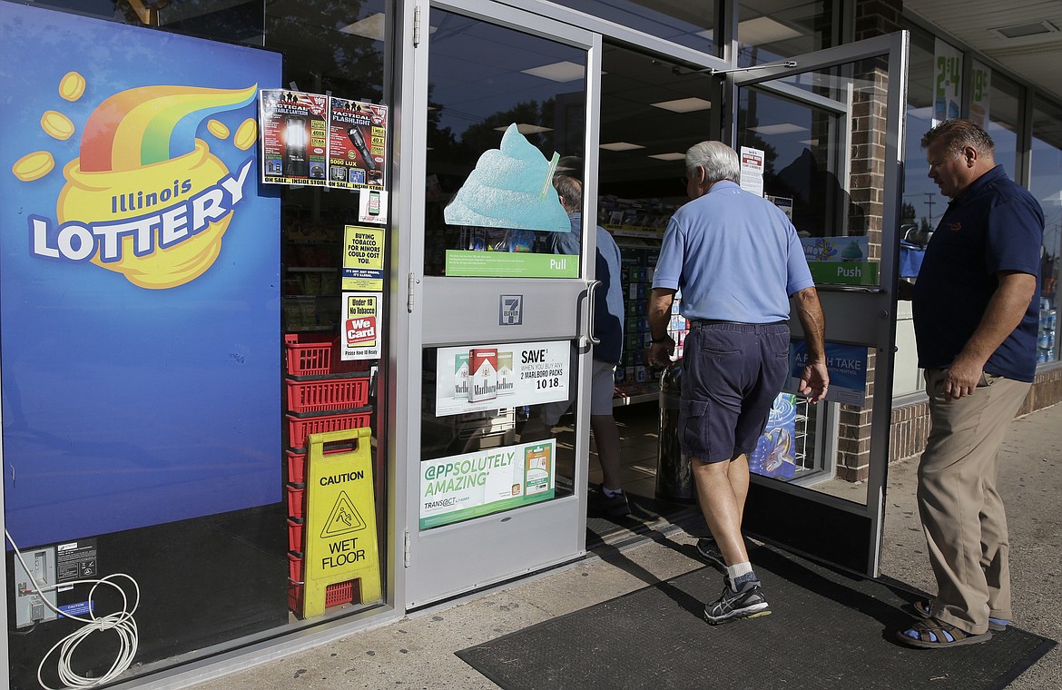 Customers walk into a convenience store to buy Powerball lottery tickets in Northbrook, Ill., Wednesday, Aug. 23, 2017. Lottery officials said the grand prize for Wednesday night's drawing has reached $700 million, he second -largest on record for any U.S. lottery game. (AP Photo/Nam Y. Huh)