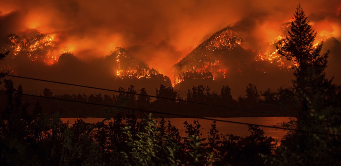 FILE--This Monday, Sept. 4, 2017, file photo provided by KATU-TV shows a wildfire as seen from near Stevenson Wash., across the Columbia River, burning in the Columbia River Gorge above Cascade Locks, Ore. The fast-moving wildfire chewing through Oregon&#146;s Columbia River Gorge is threatening more than homes and people. It&#146;s also devouring the heart of the state&#146;s nature-loving identity. (Tristan Fortsch/KATU-TV via AP, file)