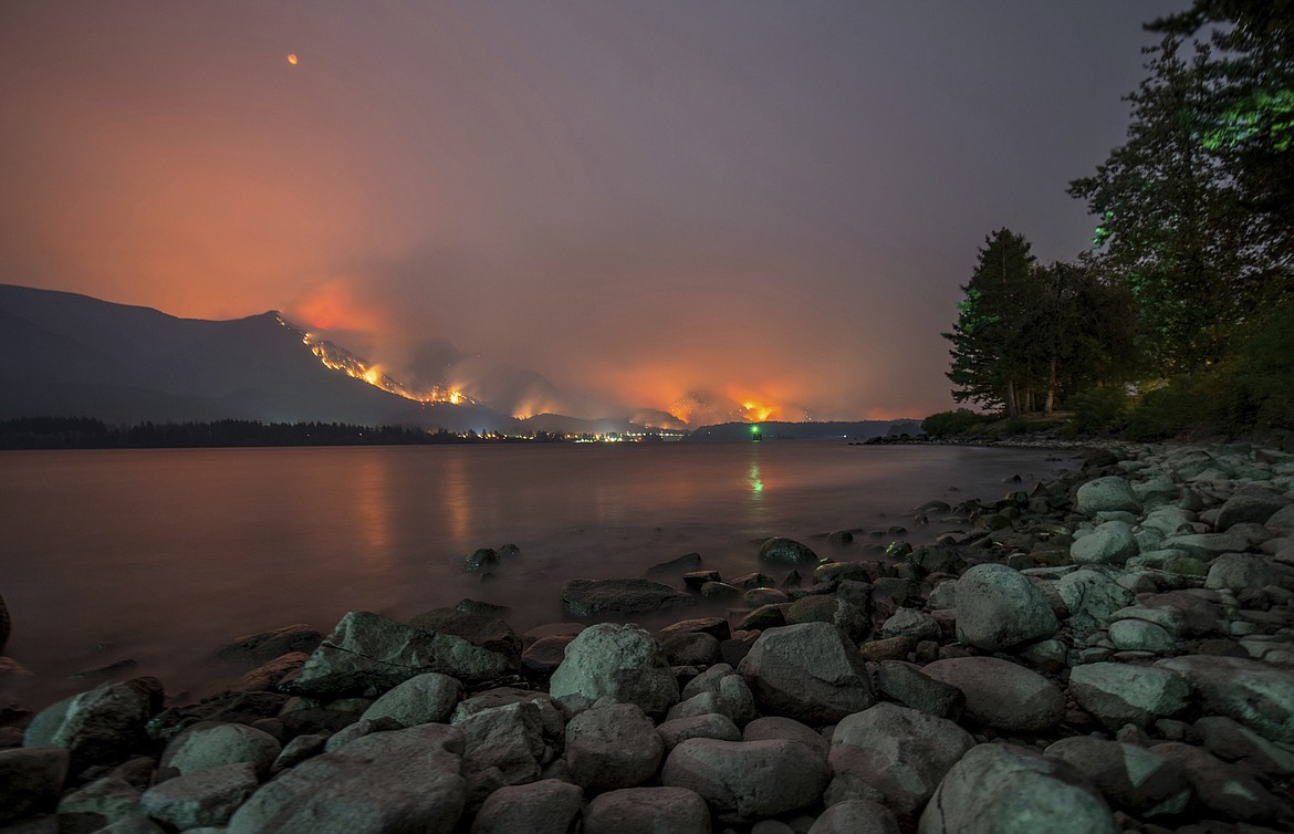 This Monday, Sept. 4, 2017, photo provided by KATU-TV shows a wildfire as seen from near Stevenson Wash., across the Columbia River, burning in the Columbia River Gorge above Cascade Locks, Ore. A lengthy stretch of highway Interstate 84 remains closed Tuesday, Sept. 5, as crews battle the growing wildfire that has also caused evacuations and sparked blazes across the Columbia River in Washington state. (Tristan Fortsch/KATU-TV via AP)