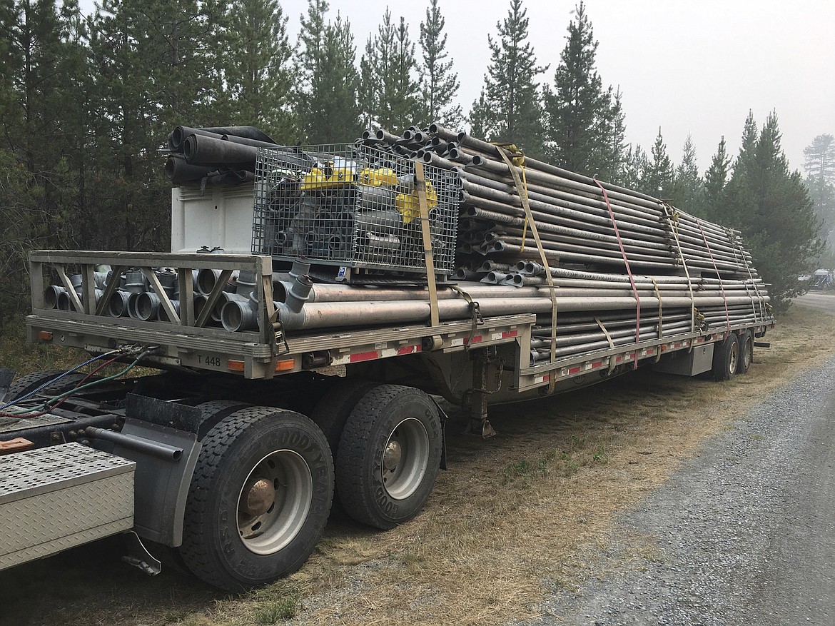 This undated photo provided by Inciweb, shows high-capacity pumps, pipes, and sprinklers that are headed for Lake McDonald Lodge in Glacier National Park, Mont. The water system is supposed to create a curtain of water, if necessary, to hold off a wildfire that already destroyed a century-old backcountry chalet. (Inciweb via AP)