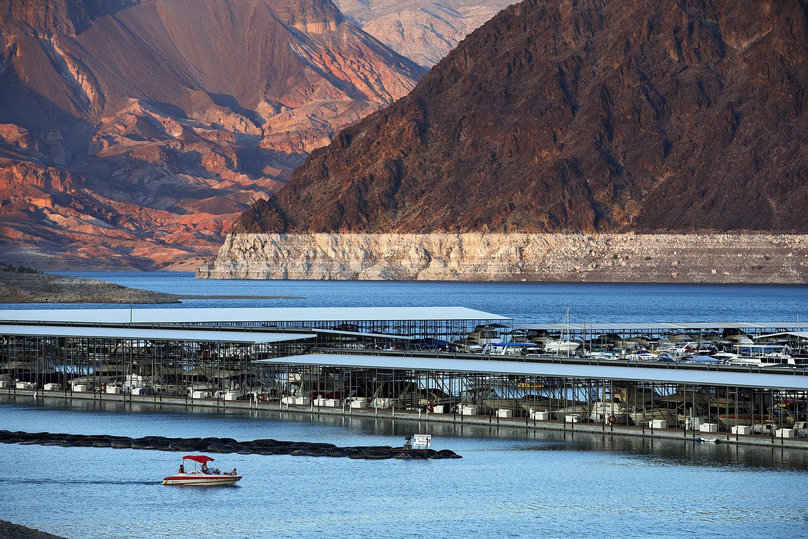 FILE - In this July 18, 2014 file photo, the bathtub ring of light minerals that delineates the high water mark on Lake Mead is seen at Hemenway Harbor in the Lake Mead National Recreation Area in Nevada. Hawaii residents and an organization representing federal workers filed a lawsuit against the Federal Aviation Administration on Wednesday, Oct. 4, 2017 seeking to force it to do something about tour helicopters buzzing around seven national parks across the country.  (AP Photo/John Locher, File)