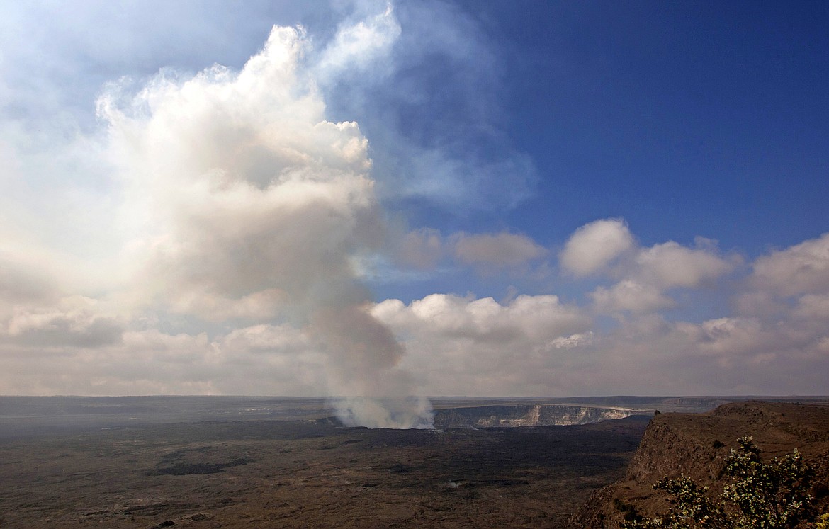 FILE - This Sept. 1, 2015 file photo shows volcanic gas rising from the lava lake in Kilauea&#146;s Halemaumau Crater in Hawaii Volcanoes National Park on Hawaii&#146;s Big Island. Hawaii residents and an organization representing federal workers filed a lawsuit against the Federal Aviation Administration on Wednesday, Oct. 4, 2017 seeking to force it to do something about tour helicopters buzzing their communities and national parks across the country. (AP Photo/Caleb Jones, File)