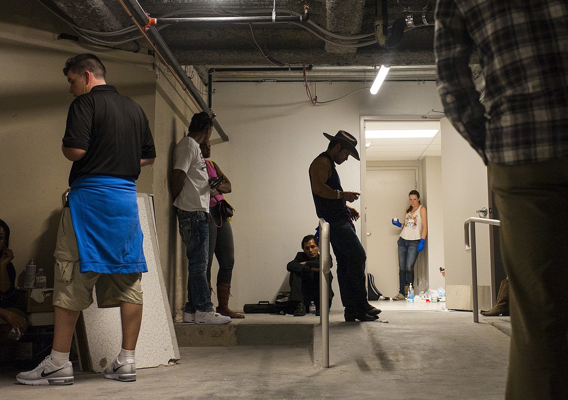 People wait as the Tropicana Las Vegas goes on lockdown during an active shooter situation on the Las Vegas Strip in Las Vegas on Sunday, Oct. 1, 2017. Multiple victims were being transported to hospitals after a shooting late Sunday at a music festival on the Las Vegas Strip. (Chase Stevens/Las Vegas Review-Journal via AP)