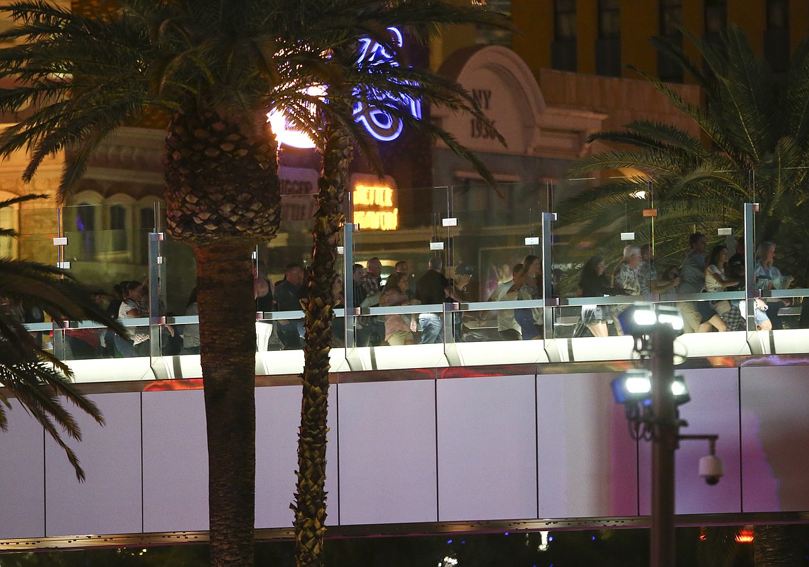 People run from the New York New York during an active shooter situation on the Las Vegas Stirp in Las Vegas Sunday, Oct. 1, 2017. Multiple victims were being transported to hospitals after a shooting late Sunday at a music festival on the Las Vegas Strip. (Chase Stevens/Las Vegas Review-Journal via AP)