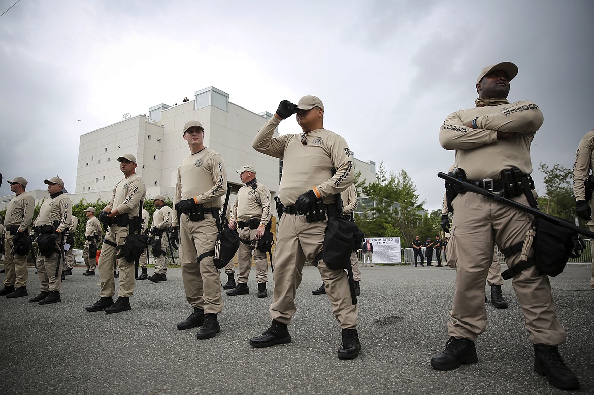 Troopers with the Florida Highway Patrol Quick Response Force line in front of the Phillips Center on the University of Florida campus in Gainesville ahead of white nationalist Richard Spencer&#146;s speech, Thursday, Oct. 19, 2017.  The school estimates it is spending $600,000 on security to ensure no repeat of violent clashes connected to a white nationalist gathering in Charlottesville, Va. (Will Vragovic/Tampa Bay Times via AP)