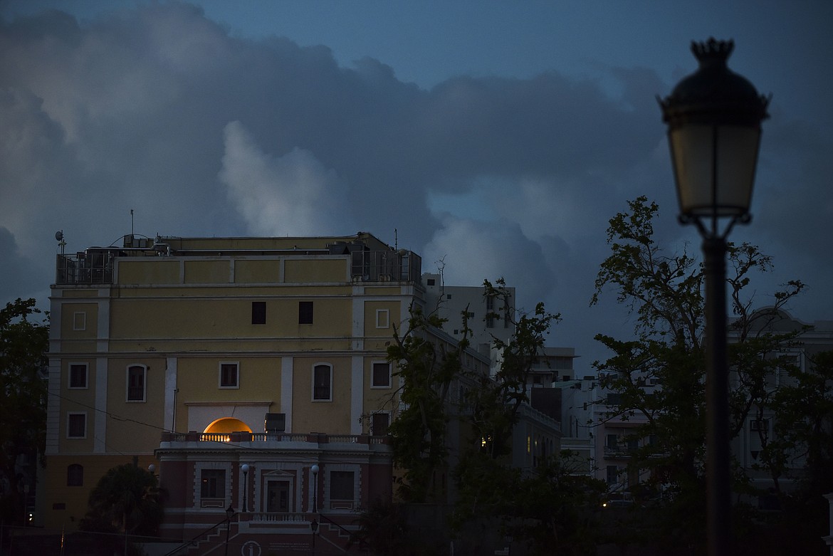 In this Friday, Oct. 20, 2017 photo, the streets of Old San Juan are dark after sunset one month after Hurricane Maria in San Juan, Puerto Rico. Tourism, a rare thriving sector on the island in a deep economic slump, is practically nonexistent a month after Hurricane Maria swept though. (AP Photo/Carlos Giusti)