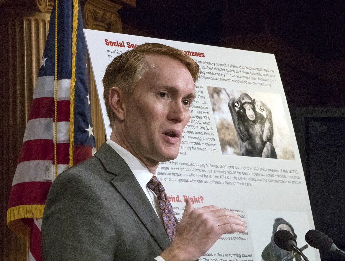 Sen. James Lankford, R-Okla., a member of the Senate Appropriations Committee, holds a news conference to outline the release of his report on wasteful spending in the federal government, on Capitol Hill in Washington, Monday, Nov. 27, 2017. Lankford stands beside a chart that points to the expense of feed and care for chimpanzees that were used for medical research. (AP Photo/J. Scott Applewhite)