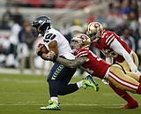 Wilson throws for 2 TDs, runs for another as Seahawks win