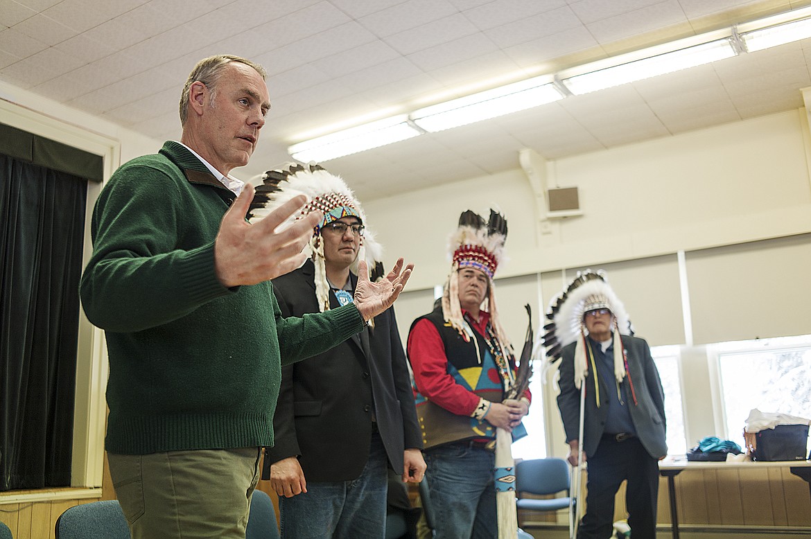 Sec. of Interior Ryan Zinke, foreground talks to Blackfeet and Glacier Park leaders during a gathering last week at Park headquarters. To his left are Tyson Runningwolf, Tim Davis and Harry Barnes.