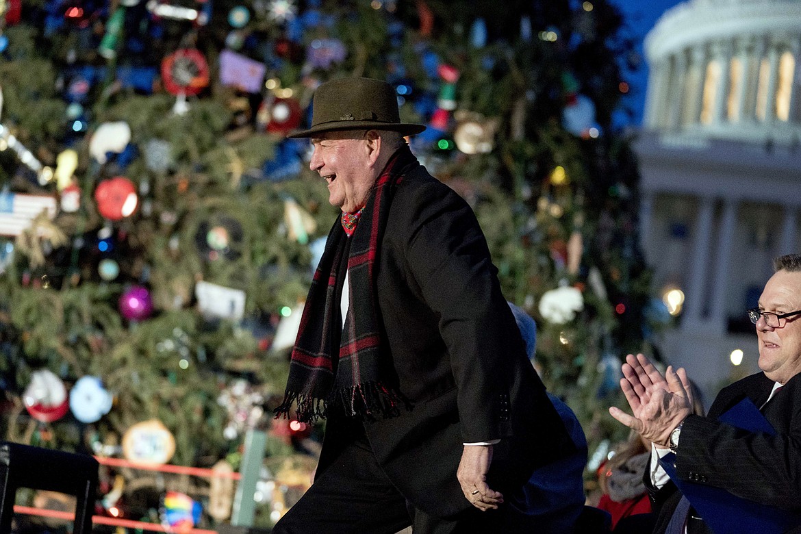 Agriculture Secretary Sonny Perdue, walks to a podium to speak during the 2017 Capitol Christmas Tree lighting ceremony on the West Lawn of the U.S. Capitol, Wednesday, Dec. 6, 2017, in Washington. The Capitol Christmas Tree has been a tradition since 1964, and this year's tree was chosen from Kootenai National Forest in Montana. (AP Photo/Andrew Harnik)