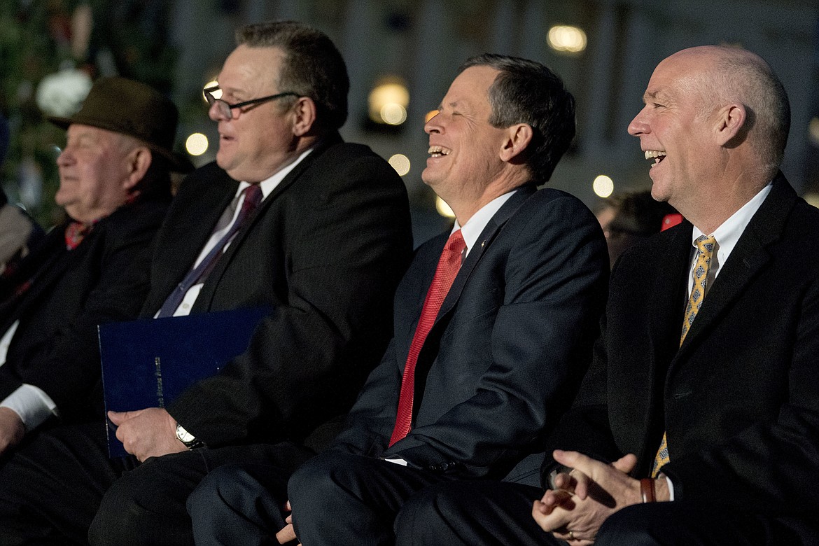 From left, Agriculture Secretary Sonny Perdue, Sen. Jon Tester, D-Mont., Sen. Steve Daines, R-Mont., and Rep. Greg Gianforte, R-Mont., attends the 2017 Capitol Christmas Tree lighting ceremony on the West Lawn of the U.S. Capitol, Wednesday, Dec. 6, 2017, in Washington. (AP Photo/Andrew Harnik)