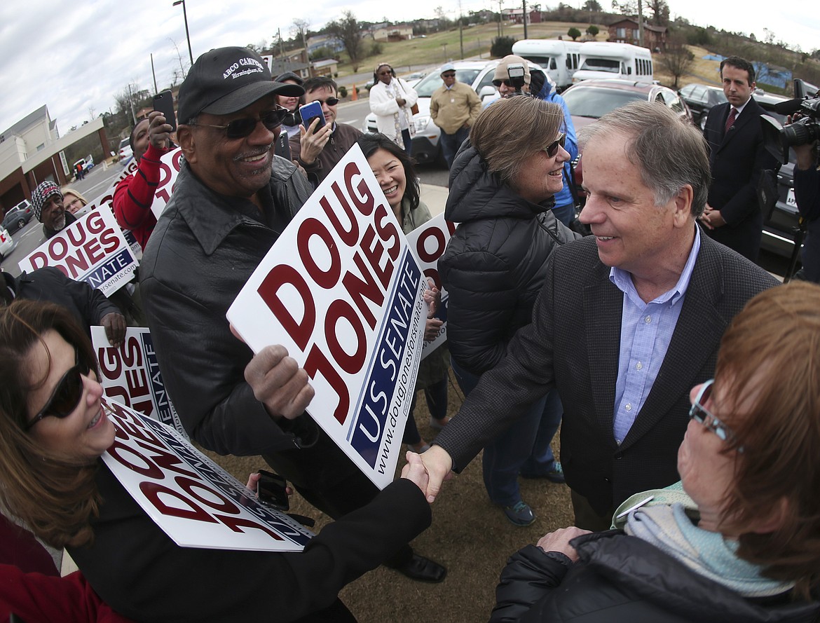 Democratic candidate for U.S. Senate Doug Jones greets supporters and voters outside Bethal Baptist Church Tuesday, Dec. 12, 2017, in Birmingham , Ala.   Jones is facing Republican Roy Moore. (AP Photo/John Bazemore)