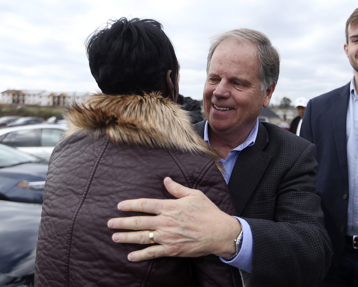 Democratic candidate for U.S. Senate Doug Jones embraces a supporter outside Bethel Baptist Church Tuesday, Dec. 12, 2017, in Birmingham , Ala. Jones is facing Republican Roy Moore. (AP Photo/John Bazemore)