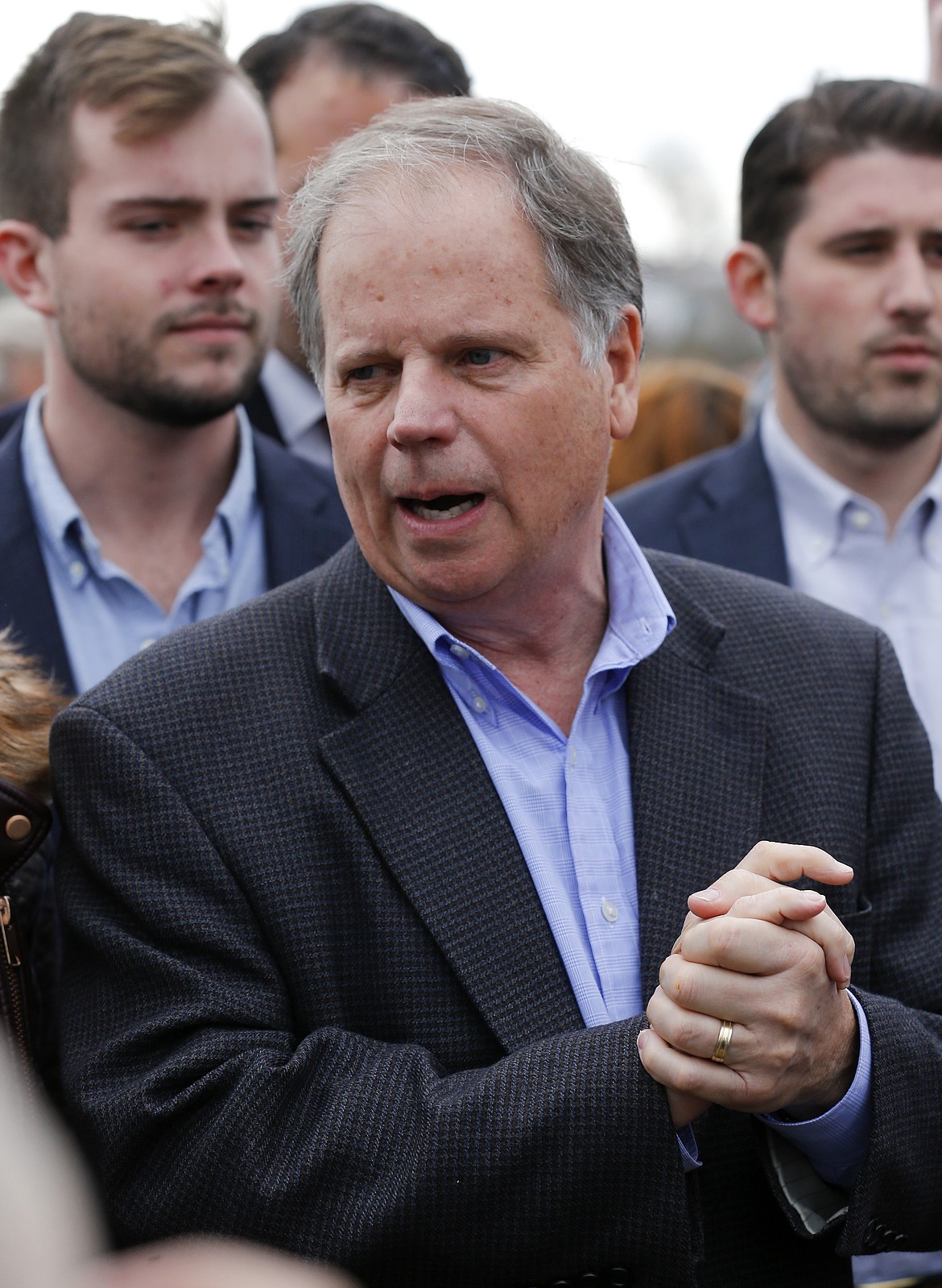 Democratic candidate for U.S. Senate Doug Jones speaks to reporters outside Bethel Baptist Church Tuesday, Dec. 12, 2017, in Birmingham , Ala. Jones is facing Republican Roy Moore. (AP Photo/John Bazemore)