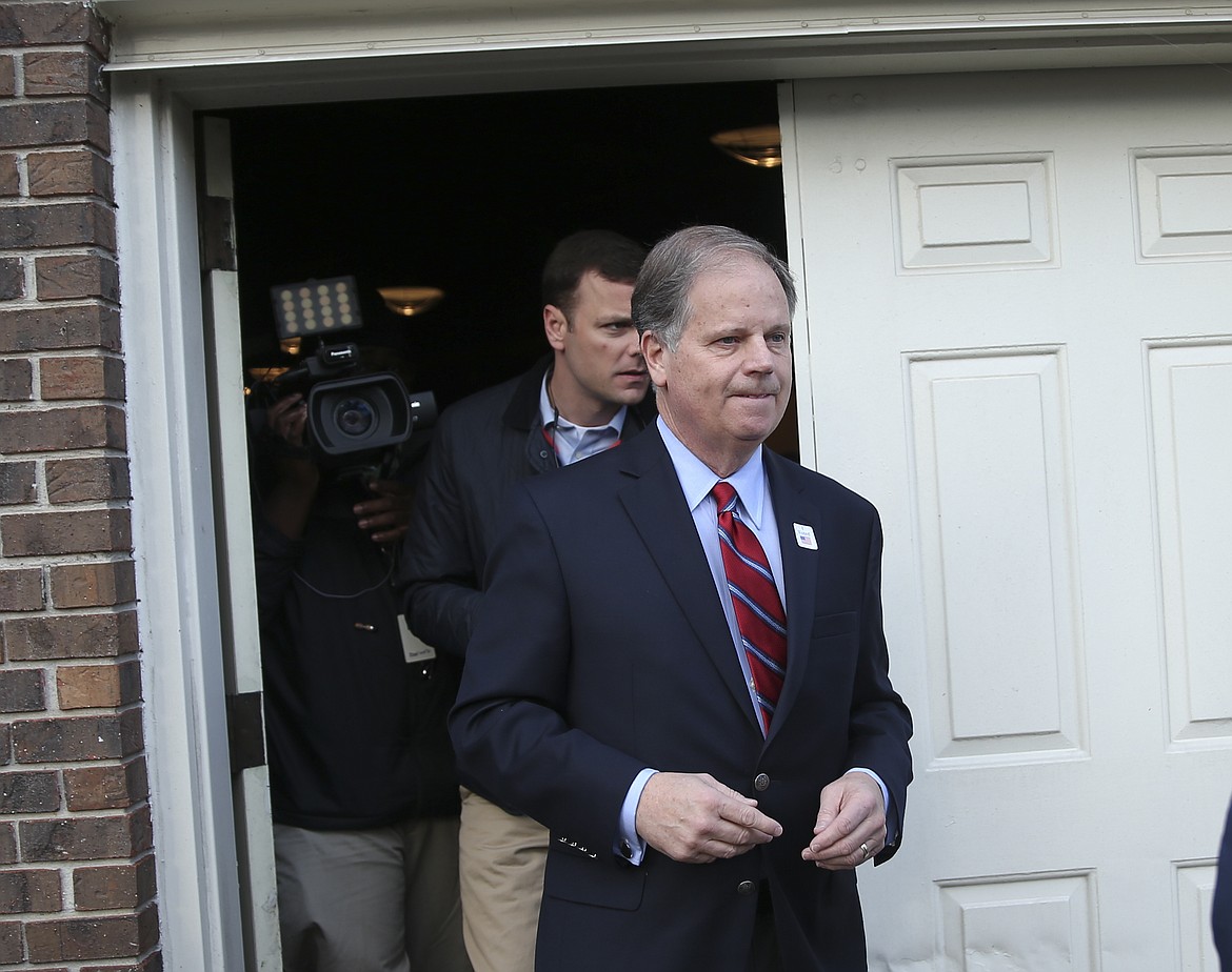 Democratic candidate for U.S. Senate Doug Jones leaves after casting his ballot Tuesday, Dec. 12, 2017, in Mountain Brook , Ala. Jones is facing Republican Roy Moore. (AP Photo/John Bazemore)