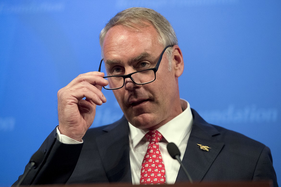 FILE - In this Sept. 29, 2017 file photo Interior Secretary Ryan Zinke speaks on the Trump Administration's energy policy at the Heritage Foundation in Washington. A U.S. Interior Department official has reacted harshly to the resignation of most members of a board that advises it on national parks. Associate Deputy Secretary Todd Willens said Wednesday, Jan. 17, 2018, that members of the National Park System Advisory Board ignored sexual harassment at national parks and praised a former parks official who had been criticized for ethics and management failures. (AP Photo/Andrew Harnik,File)