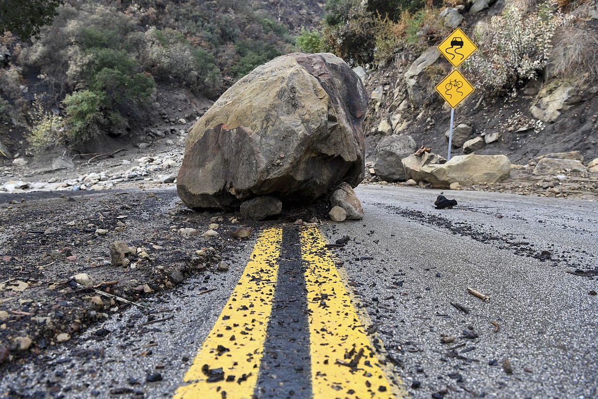 A large boulder sits in the middle of Bella Vista Drive in Montecito, Calif., following the rain storm, Tuesday, Jan. 9, 2018. (AP Photo/Michael Owen Baker)