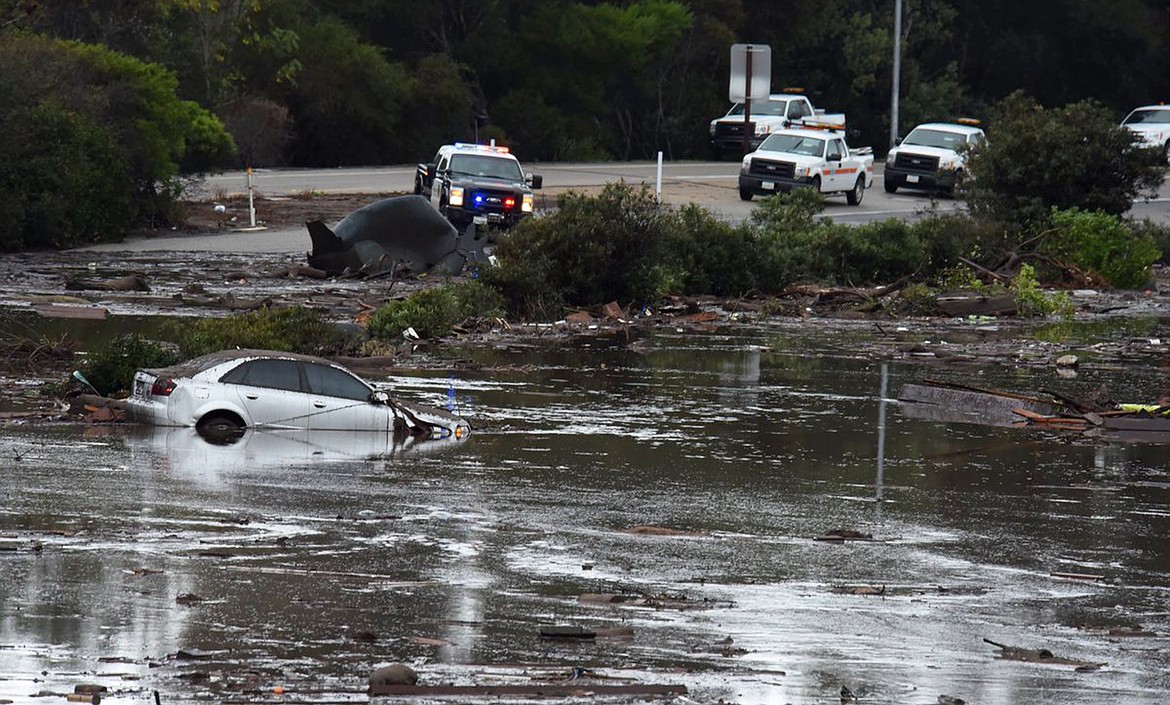 This photo provided by the Santa Barbara County Fire Department shows the U.S. Highway 101 at the Olive Mill Road overpass flooded with runoff water from Montecito Creek in Montecito, Calif., Tuesday, Jan. 9, 2018. Dozens of homes were swept away or heavily damaged Tuesday as downpours sent mud and boulders roaring down hills stripped of vegetation by a gigantic wildfire that raged in Southern California last month. (Mike Eliason/Santa Barbara County Fire Department via AP)