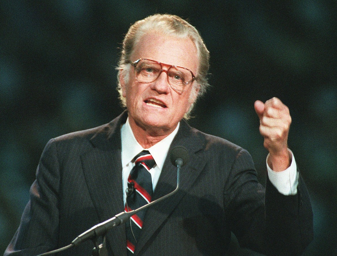 FILE - In this Oct 26, 1994 file photo, Evangelist Billy Graham begins his sermon in Atlanta's Georgia Dome.   Graham, who transformed American religious life through his preaching and activism, becoming a counselor to presidents and the most widely heard Christian evangelist in history, has died. Spokesman Mark DeMoss says Graham, who long suffered from cancer, pneumonia and other ailments, died at his home in North Carolina on Wednesday, Feb. 21, 2018. He was 99. (AP Photo/John Bazemore, File)