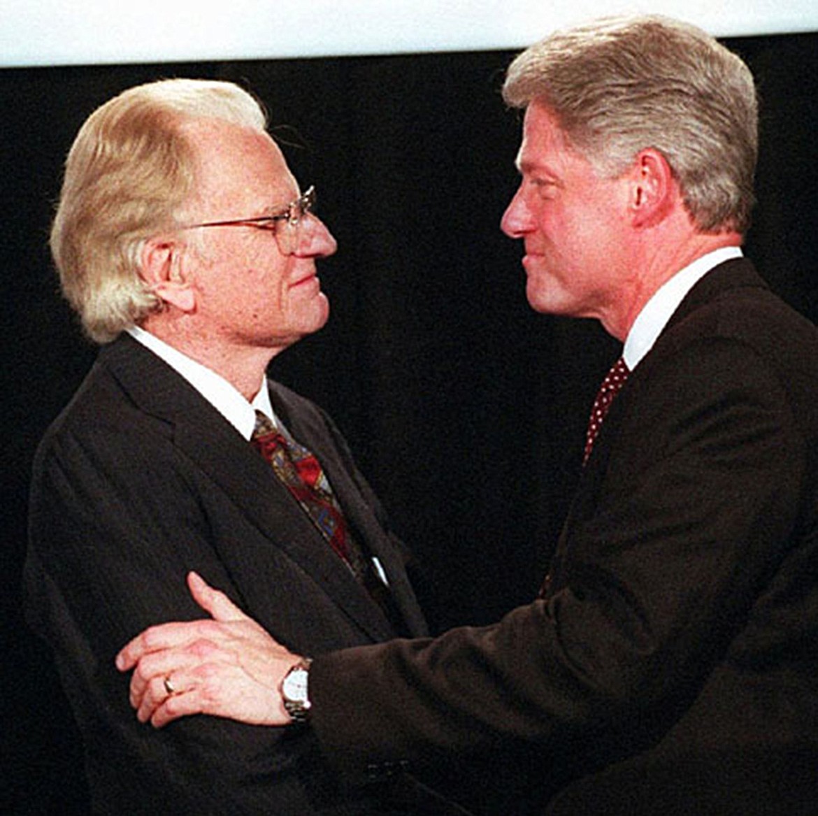 Billy Graham and President Bill Clinton talk before Graham's address on May 2, 1996. (Gary O'Brien/Charlotte Observer/TNS)