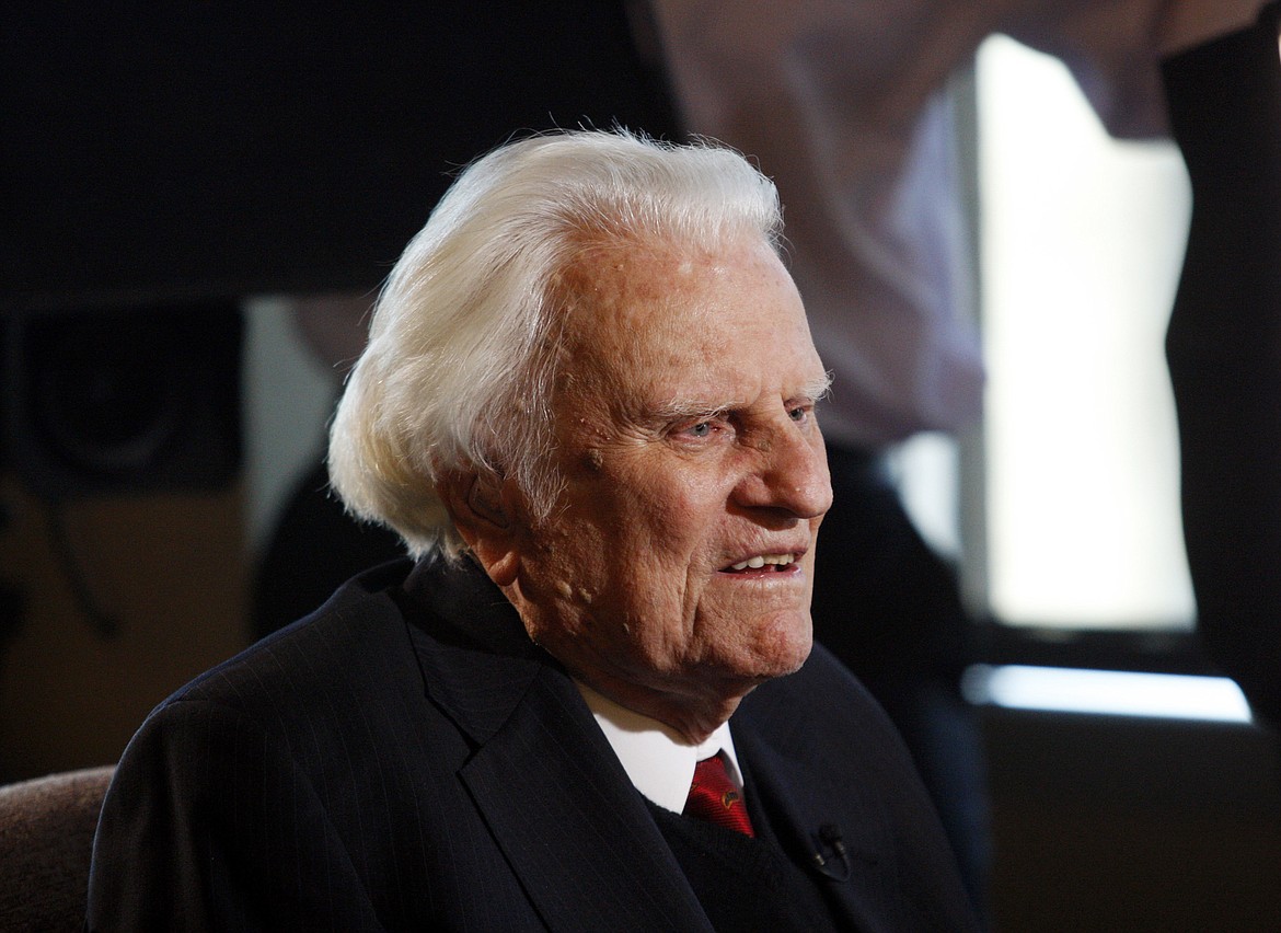 FILE - In this Dec. 20, 2010 file photo, evangelist Billy Graham, 92, speaks during an interview at the Billy Graham Evangelistic Association headquarters in Charlotte, N.C.    Graham, who transformed American religious life through his preaching and activism, becoming a counselor to presidents and the most widely heard Christian evangelist in history, has died. Spokesman Mark DeMoss says Graham, who long suffered from cancer, pneumonia and other ailments, died at his home in North Carolina on Wednesday, Feb. 21, 2018. He was 99. (AP Photo/Nell Redmond, File)