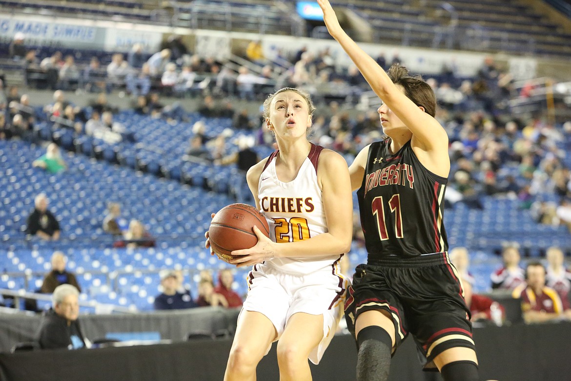 Connor Vanderweyst/Columbia Basin HeraldMoses Lake's Camille Carpenter drives the lane guarded by University's Claire Dingus during the state quarterfinals Thursday at the Tacoma Dome.