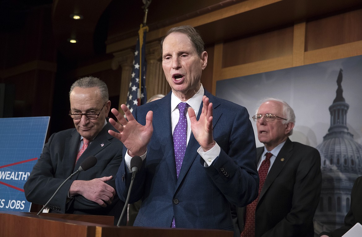 Senate Finance ranking member Ron Wyden, D-Ore., center, flanked by Senate Minority Leader Chuck Schumer, D-N.Y., left, and Senate Budget Committee Ranking Member Bernie Sanders, I-Vt., speaks to reporters during a news conference to criticize President Donald Trump&#146;s tax cuts and call for putting government funds toward a $1 trillion infrastructure package, at the Capitol in Washington, Wednesday, March 7, 2018. (AP Photo/J. Scott Applewhite)