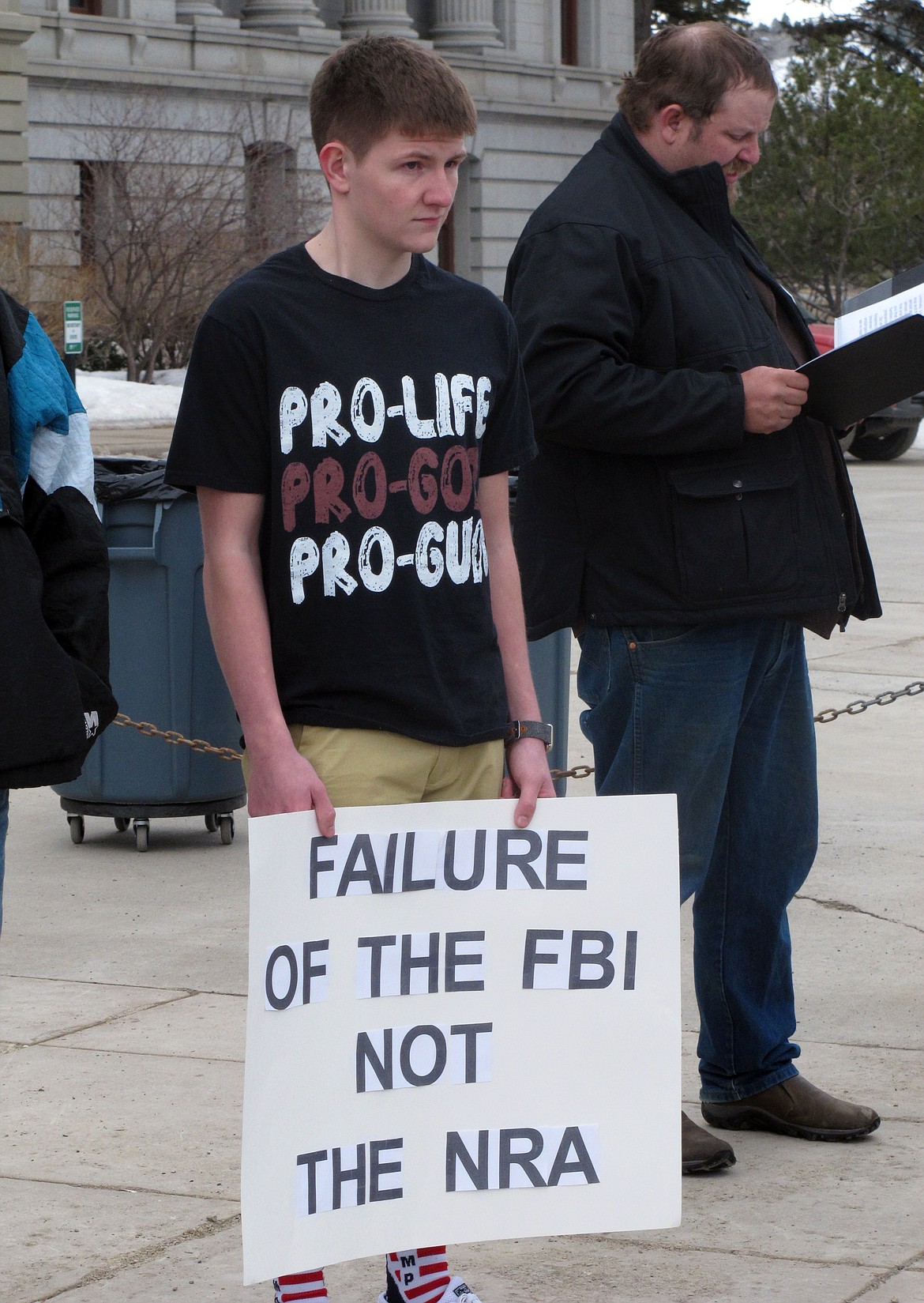 High school student Braxton Shewalter holds a sign while attending a protest at the Montana State Capitol on Saturday, March 24, 2018, in Helena, Mont. The gun rights counter-protest was held at the same time and across town from the larger rally held by students and gun-control advocates (AP Photo/Matt Volz)