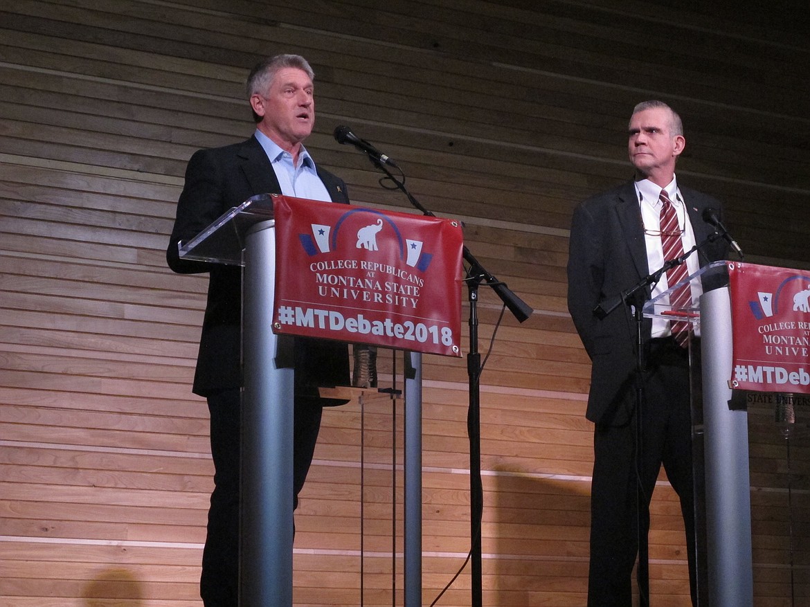 Businessman Troy Downing gives introductory remarks as State Auditor Matt Rosendale looks on during a U.S. Senate debate for Republican candidates on Thursday, March 22, 2018, in Bozeman, Montana. Downing and Rosendale are two of the four candidates competing for the GOP nomination in the June 5 primary elections and the chance to take on incumbent Democratic Sen. Jon Tester. (AP Photo/Matt Volz)