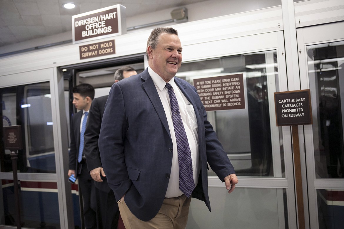 FILE - In this Jan. 25, 2018 file photo, Sen. Jon Tester, D-Mont., arrives for voting at the Capitol in Washington. Tester is trying to appeal to Montana voters who elected President Donald Trump in a new campaign ad.  (AP Photo/J. Scott Applewhite, File)