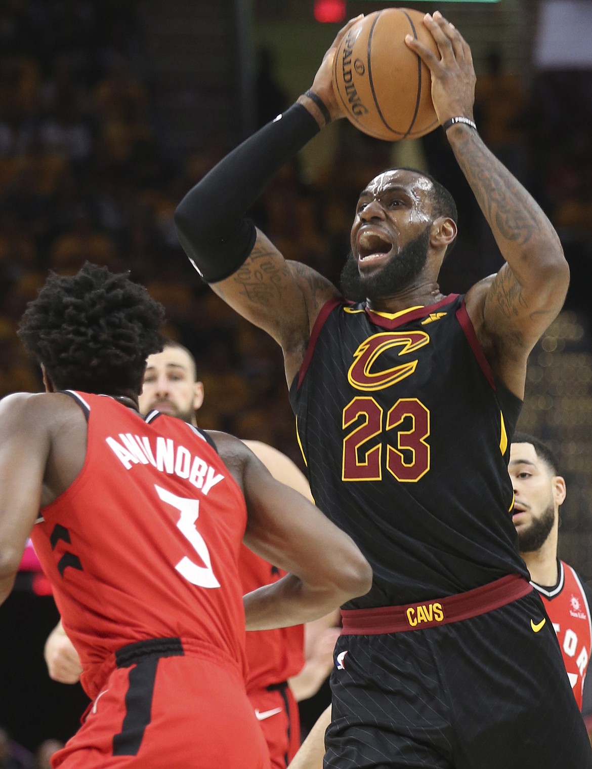 Cleveland Cavaliers' LeBron James looks to pass around Toronto Raptors' OG Anunoby during the first quarter of Game 4 of a second-round playoff series on Monday, May 7, 2018 in Cleveland, Ohio. (Phil Masturzo/Akron Beacon Journal/TNS)