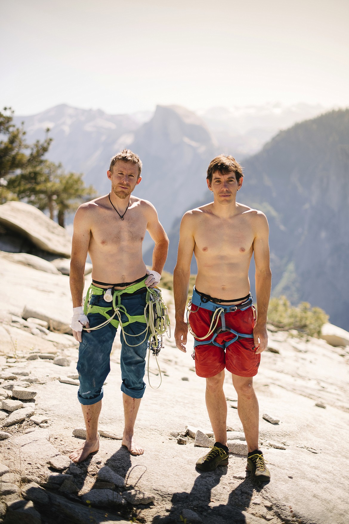 In this June 3, 2018 photo provided by Corey Rich, Alex Honnold, right, and Tommy Caldwell pose for a portrait at the top of El Capitan in Yosemite National Park, Calif. Days after two of the world's most celebrated rock climbers twice set astonishingly fast records on the biggest wall in Yosemite National Park, they did it again Wednesday, June 6, 2018, breaking a mark compared with track's four-minute mile. (Corey Rich/Reel Rock /Novus Select via AP)