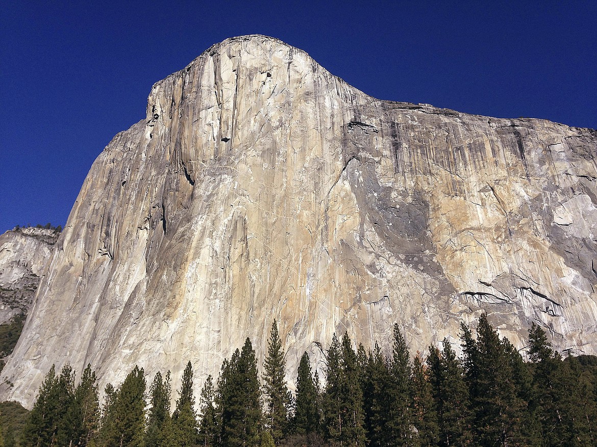 FILE - This Jan. 14, 2015 file photo shows El Capitan in Yosemite National Park, Calif. Celebrated rock climber Alex Honnold says he didn't think he and his partner Tommy Caldwell were on a record-shattering time to conquer Yosemite's El Capitan until he neared the finish line and looked at the timer on his phone. Honnold says he was slightly emotional in breaking the two-hour mark Wednesday, June 6, 2018 on the 3,000-foot (915 meters) sheer granite wall. The blisteringly fast pace - 1 hour, 58 minutes and seven seconds - capped weeks of practice climbs up the so-called Nose route that runs up the middle of the massive monolith towering above Yosemite Valley. (AP Photo/Ben Margot, File)