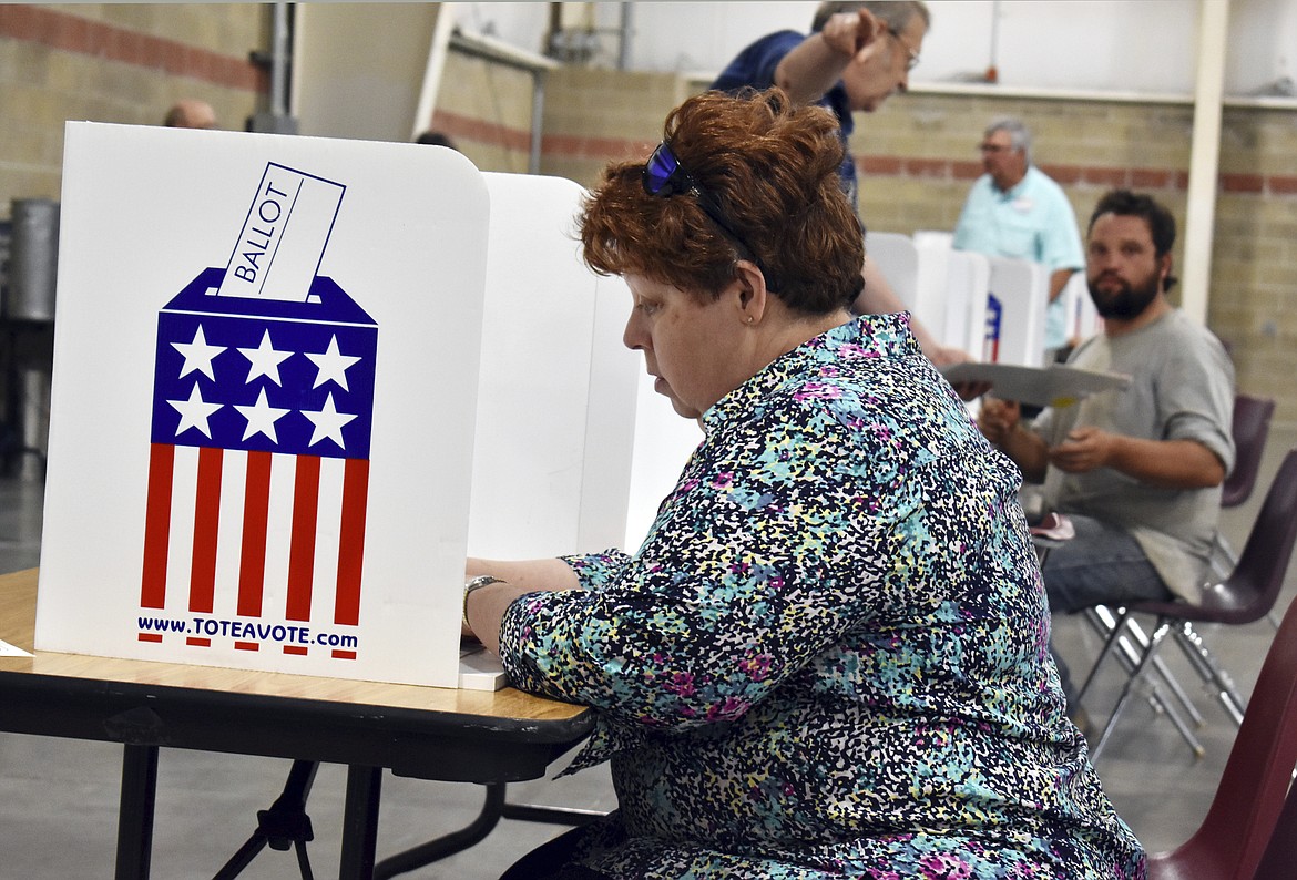 A woman fills out her election ballot at MetraPark Arena in Billings, Mont., Tuesday, June 5, 2018. Turnout was light at polling places in Montana&#146;s largest city as most voters already had cast their Primary ballots by mail. (AP Photo/Matthew Brown)