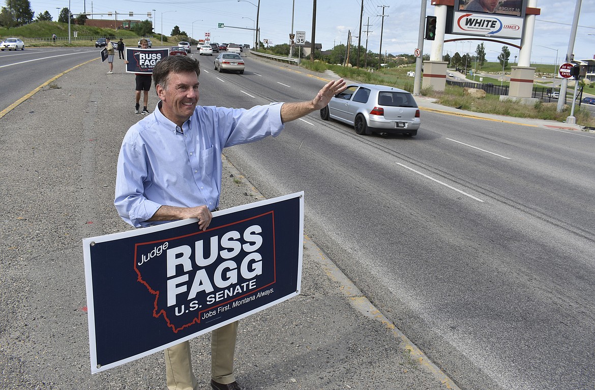 Retired state judge Russ Fagg, a candidate in Montana&#146;s Republican U.S. Senate primary, waves to drivers in a highway median, Tuesday, June 5, 2018 in Billings, Mont. Fagg says he was outspent by 4 to 1 by opponent Matt Rosendale, the state auditor. (AP Photo/Matthew Brown)