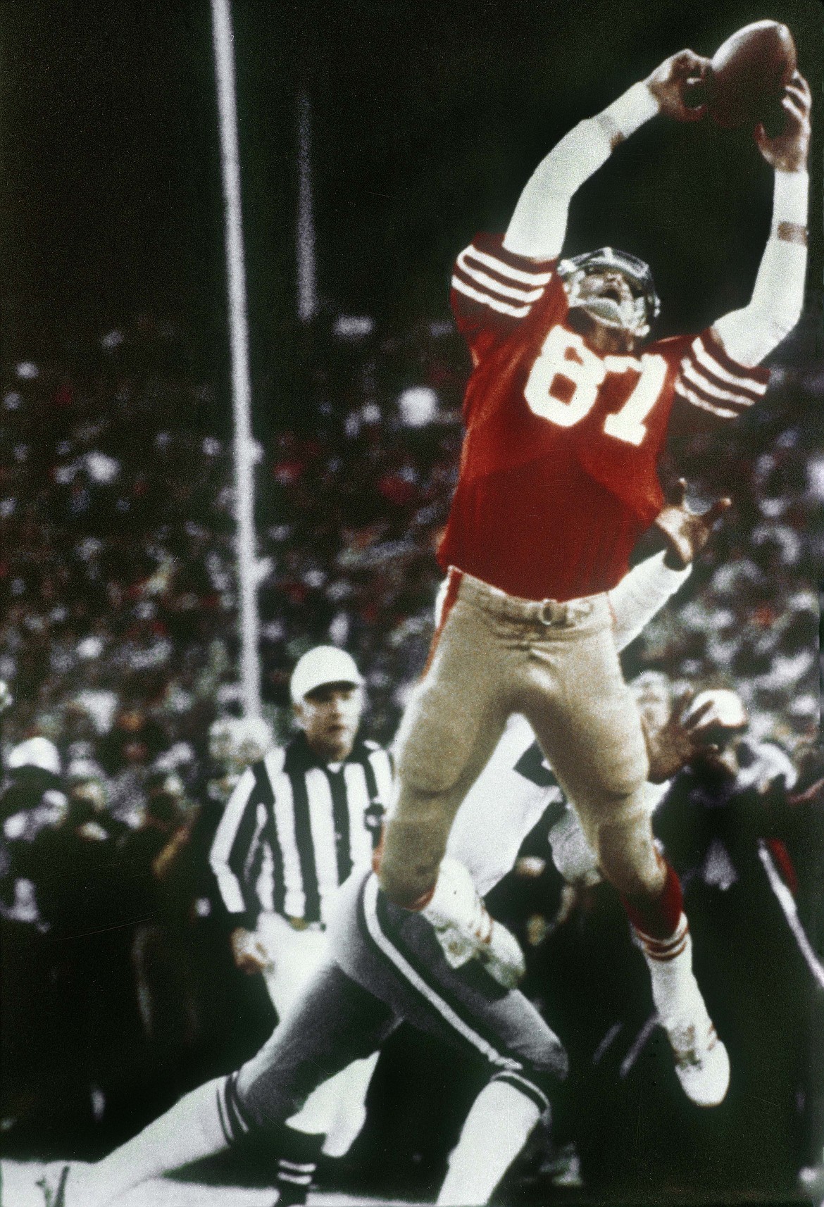 FILE - In this Jan. 10, 1982, file photo, San Francisco 49ers wide receiver Dwight Clark makes &quot;The Catch,&quot; a pass from Joe Montana that tied the game, late in the fourth quarter against the Dallas Cowboys in the NFC championship football game at Candlestick Park in San Francisco. Clark, the former 49ers wide receiver whose reception known as &quot;The Catch&quot; sent San Francisco to its first Super Bowl, has died one year after revealing he had ALS. He was 61. The team said Clark died Monday, June 4, 2018, surrounded by friends and family.(Phil Huber/The Dallas Morning News via AP, File)