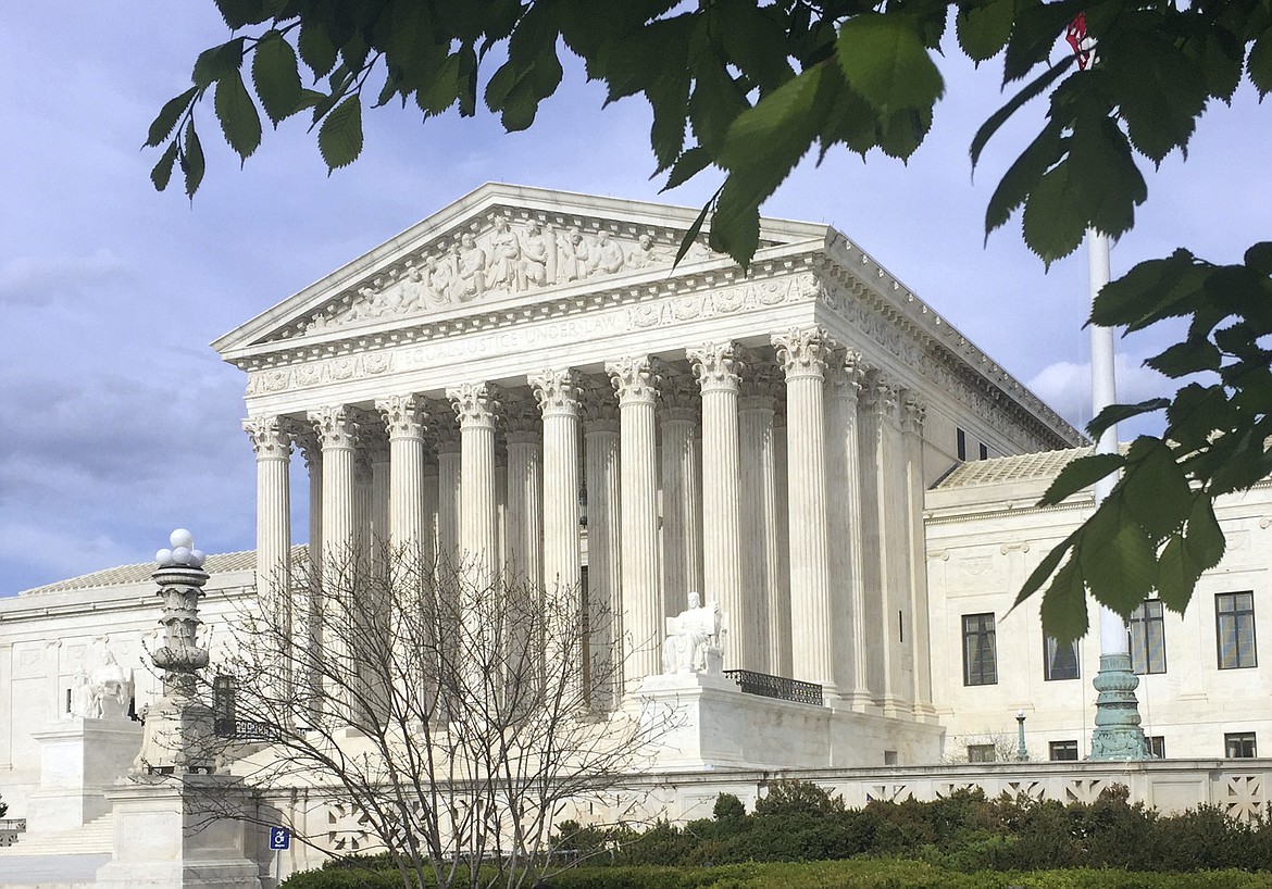 In this April 20, 2018, file photo, the Supreme Court is seen in Washington. The Supreme Court has upheld President Donald Trump&#146;s ban on travel from several mostly Muslim countries, rejecting a challenge that it discriminated against Muslims or exceeded his authority. (AP Photo/J. Scott Applewhite, File)