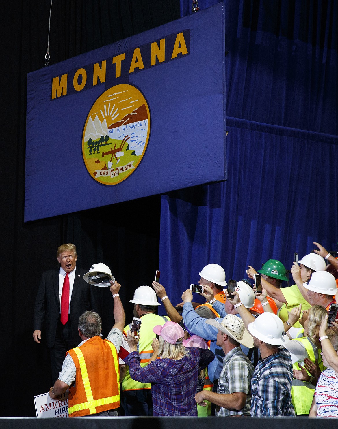 President Donald Trump arrives to a cheering rally crowd at the Four Seasons Arena at Montana ExpoPark, Thursday, July 5, 2018, in Great Falls, Mont., in support of Rep. Greg Gianforte, R-Mont., and Senate candidate Matt Rosendale. (AP Photo/Carolyn Kaster)