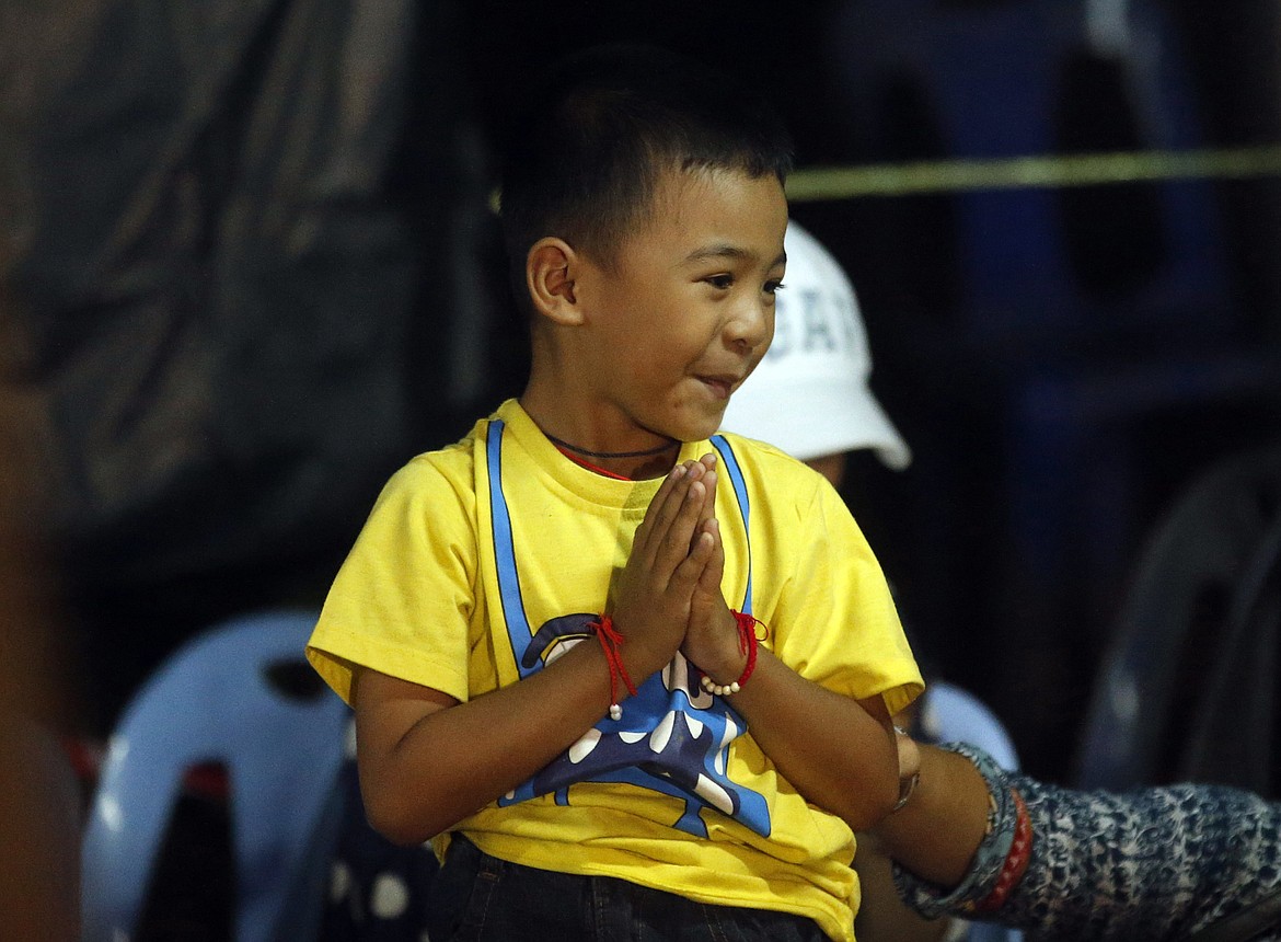 A young family member reacts after hearing the news that the missing 12 boys and their soccer coach have been found, in Mae Sai, Chiang Rai province, in northern Thailand, Monday, July 2, 2018. A Thai provincial governor says all 12 boys and their coach have been found alive in the cave where they went missing over a week ago in northern Thailand. (AP Photo/Sakchai Lalit)